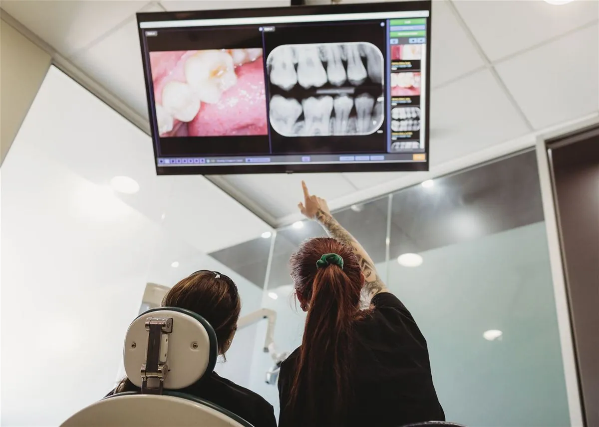 Southside Dental team members reviewing dental X-rays together on a large wall screen